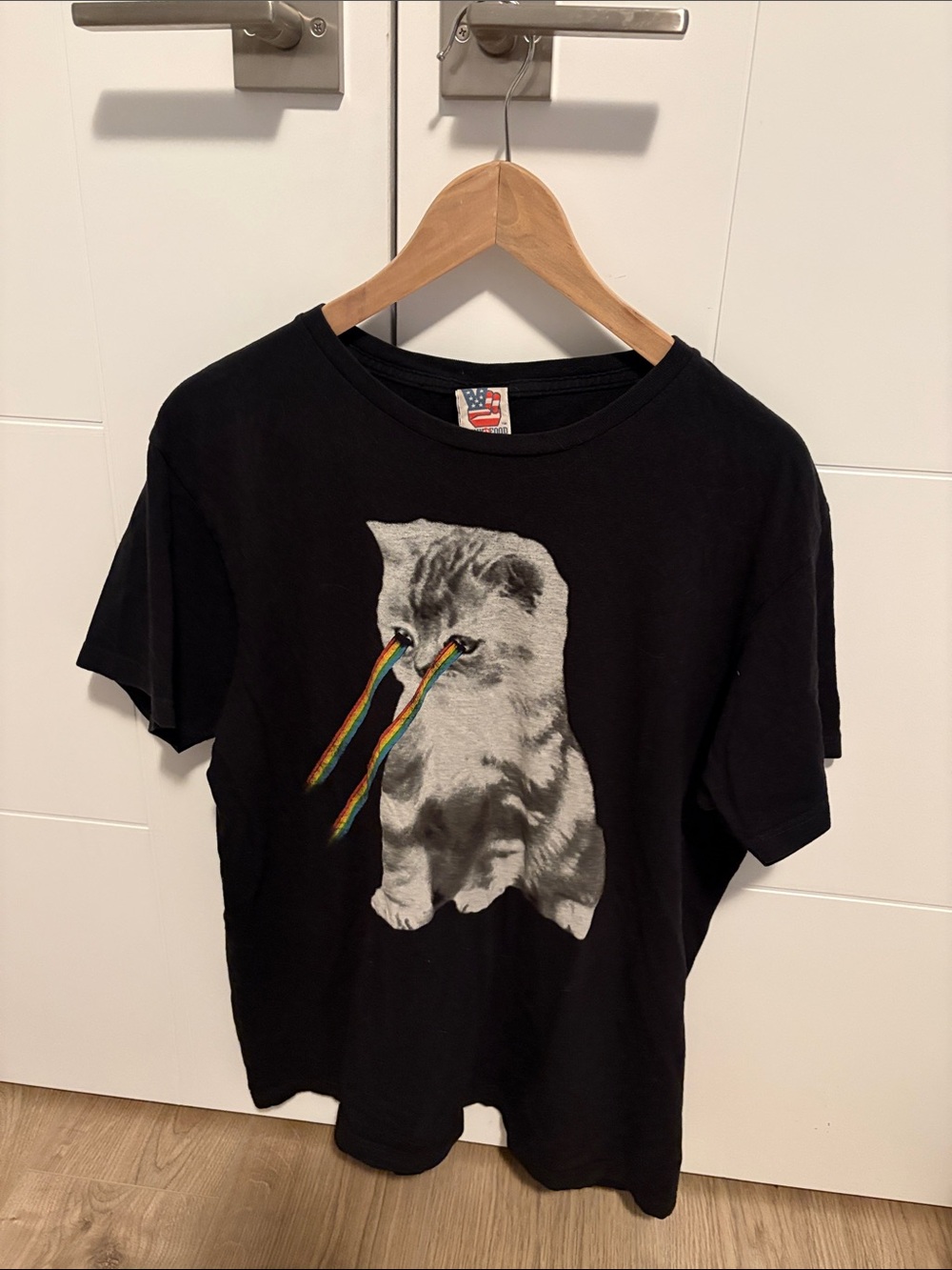 Junk Food Clothing Black Tee with Rainbow-Eyed Kitten Graphic